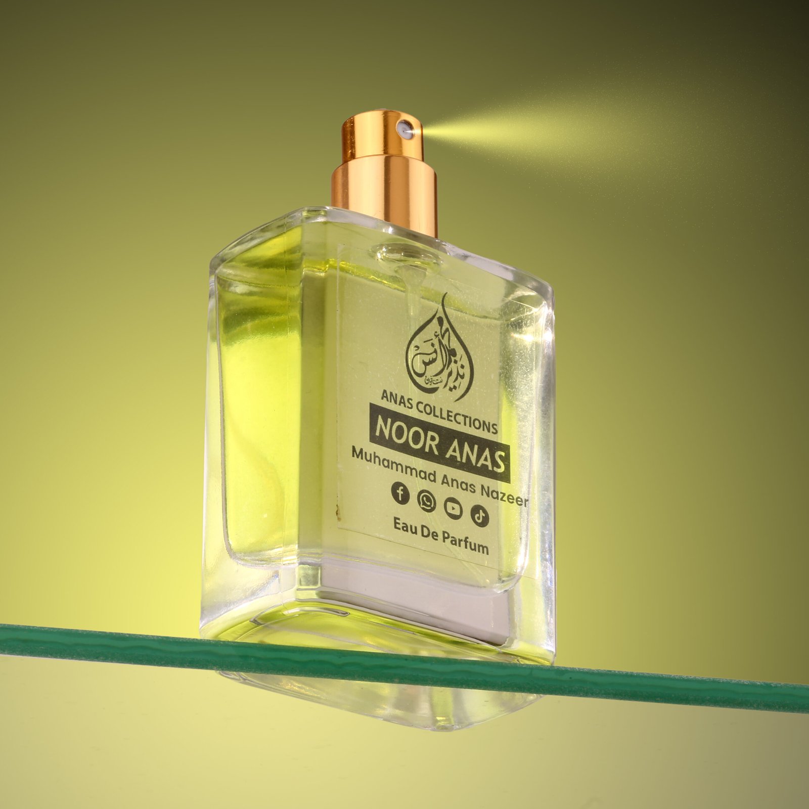 Close-up action shot of Noor Anas premium perfume spraying from a golden nozzle.